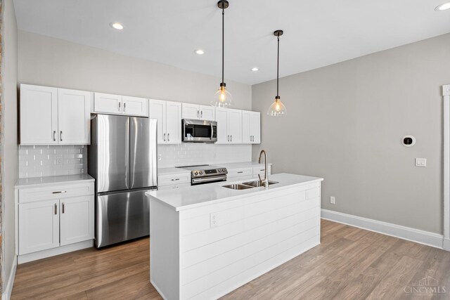 1318 Knowlton St, Cincinnati, OH 45223 - kitchen with white cabinets, stainless steel appliances, a sink, and backsplash