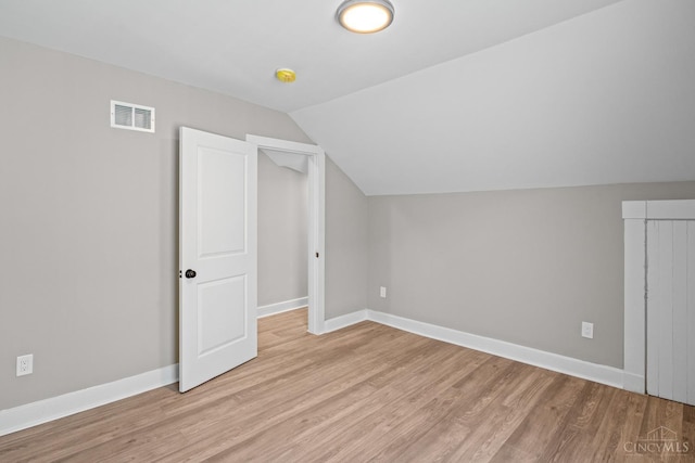 1318 Knowlton St, Cincinnati, OH 45223 - additional living space featuring baseboards, vaulted ceiling, visible vents, and light wood-type flooring