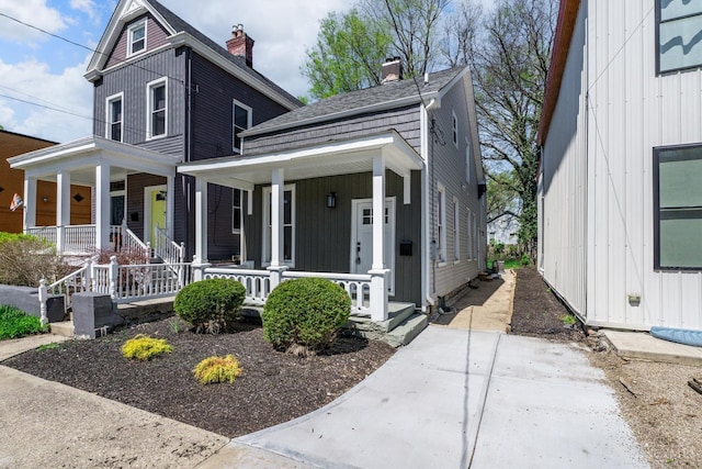 1318 Knowlton St, Cincinnati, OH 45223 - view of front facade with a chimney and covered porch