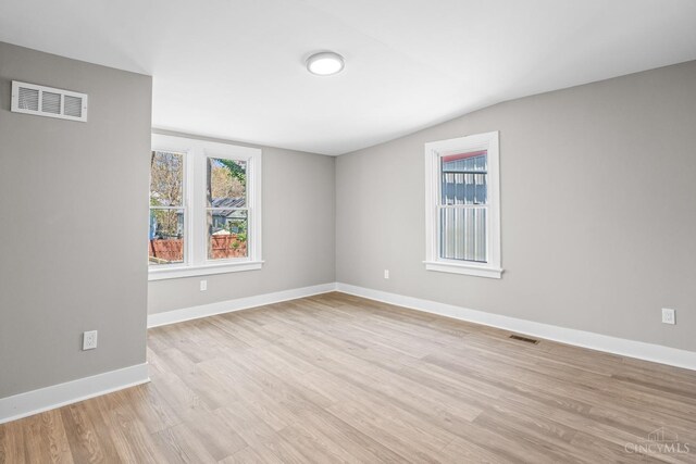1318 Knowlton St, Cincinnati, OH 45223 - empty room with lofted ceiling, visible vents, and light wood-type flooring