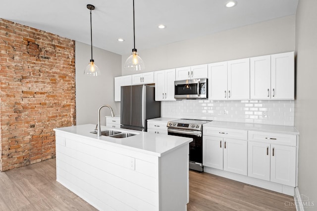 1318 Knowlton St, Cincinnati, OH 45223 - kitchen with a sink, light wood-type flooring, light countertops, white cabinets, and appliances with stainless steel finishes