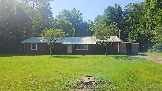 1847 Carnes Rd, Monroe Twp, OH 45157 - single story home with a front lawn, a metal roof, stucco siding, and concrete driveway