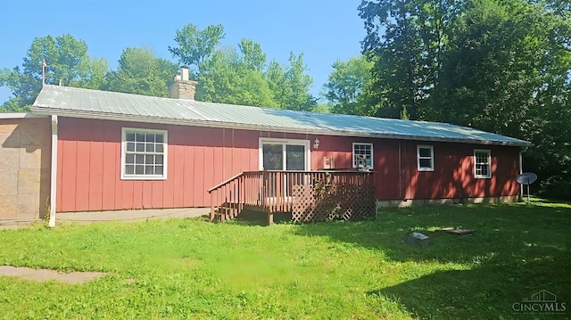 1847 Carnes Rd, Monroe Twp, OH 45157 - back of house featuring a yard, a metal roof, a chimney, and a wooden deck