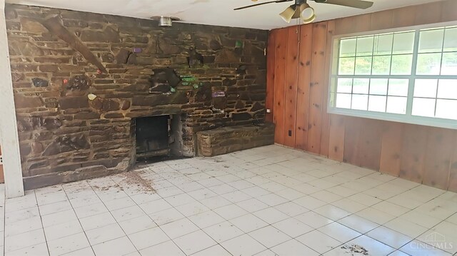 1847 Carnes Rd, Monroe Twp, OH 45157 - unfurnished living room with ceiling fan, a fireplace, and wood walls
