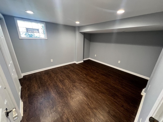 basement with dark wood-type flooring, recessed lighting, and baseboards