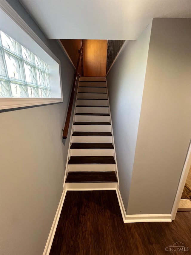 stairs featuring baseboards and wood finished floors