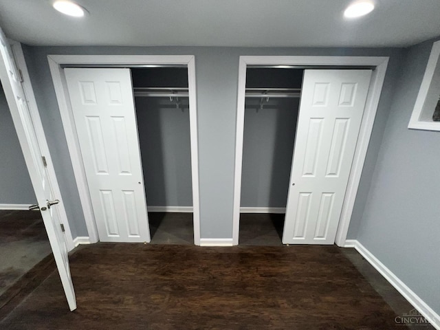 unfurnished bedroom featuring baseboards, recessed lighting, and multiple closets