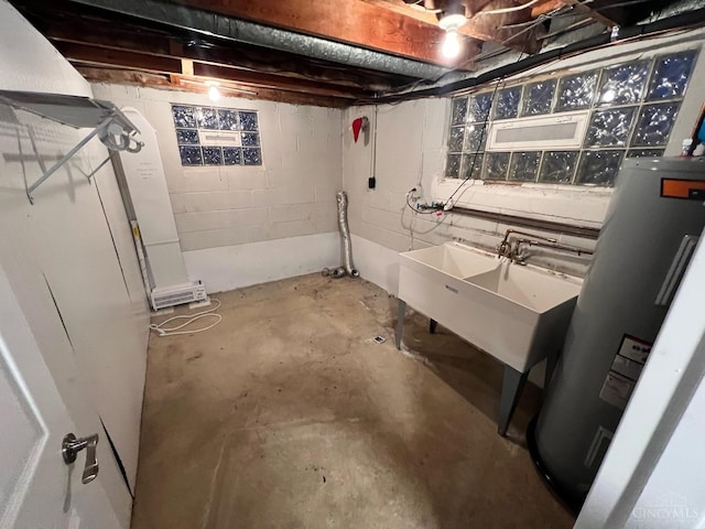 unfinished basement featuring water heater and concrete block wall