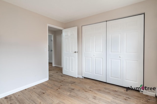 3640 Westwood Northern Blvd Unit 24, Cheviot, OH 45211 - unfurnished bedroom featuring light wood-type flooring, a closet, and baseboards
