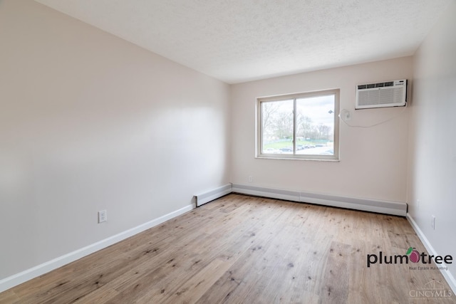 3640 Westwood Northern Blvd Unit 24, Cheviot, OH 45211 - unfurnished room with a textured ceiling, a wall unit AC, wood finished floors, a baseboard heating unit, and baseboards