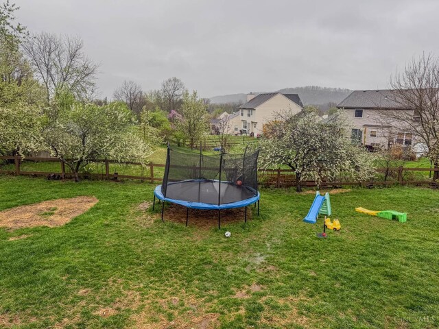 10701 Stone Ridge Way, Harrison, OH 45030 - view of jungle gym featuring fence, a yard, and a trampoline