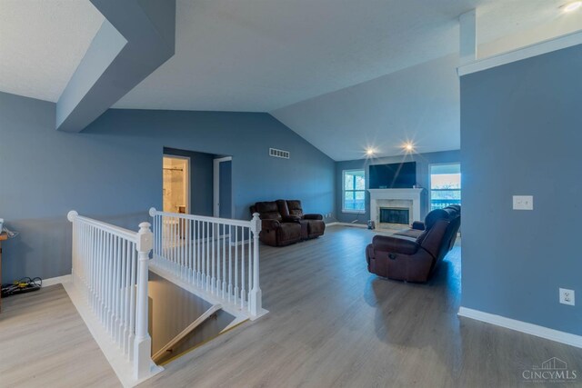 10701 Stone Ridge Way, Harrison, OH 45030 - living room featuring vaulted ceiling, wood finished floors, and baseboards
