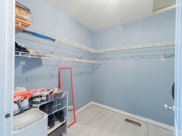 10701 Stone Ridge Way, Harrison, OH 45030 - walk in closet featuring wood finished floors and visible vents