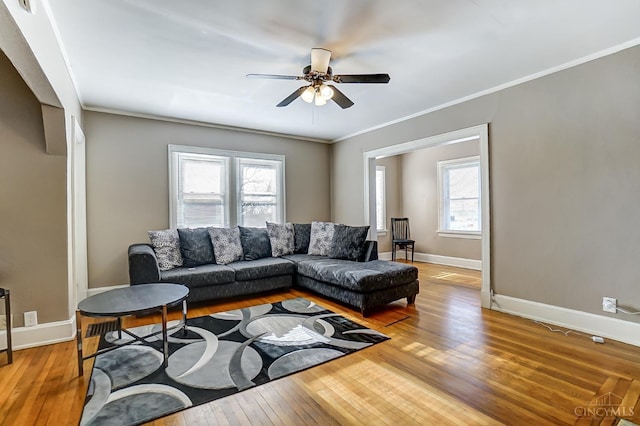living area with wood-type flooring, baseboards, and ceiling fan