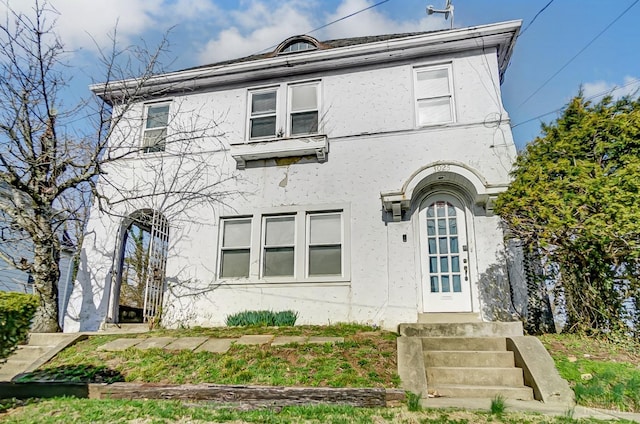 view of front of house with stucco siding and entry steps