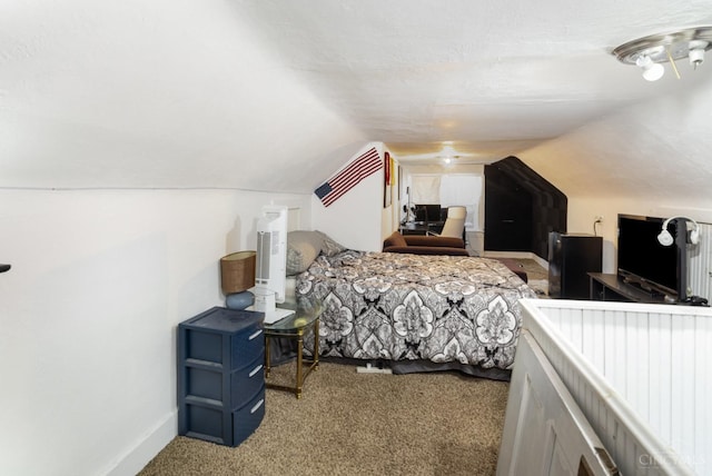 carpeted bedroom with lofted ceiling and baseboards