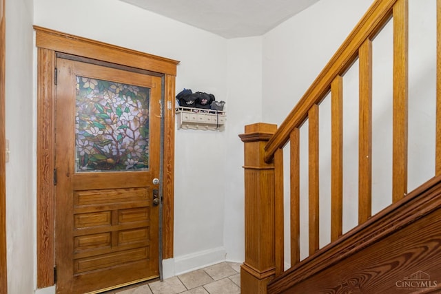entryway featuring baseboards and light tile patterned floors