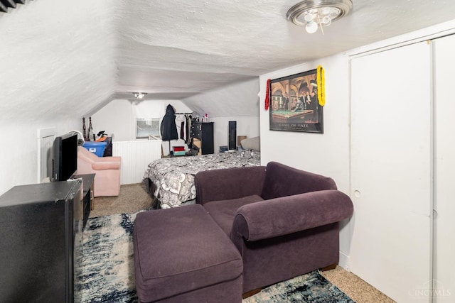 carpeted bedroom featuring vaulted ceiling and baseboards