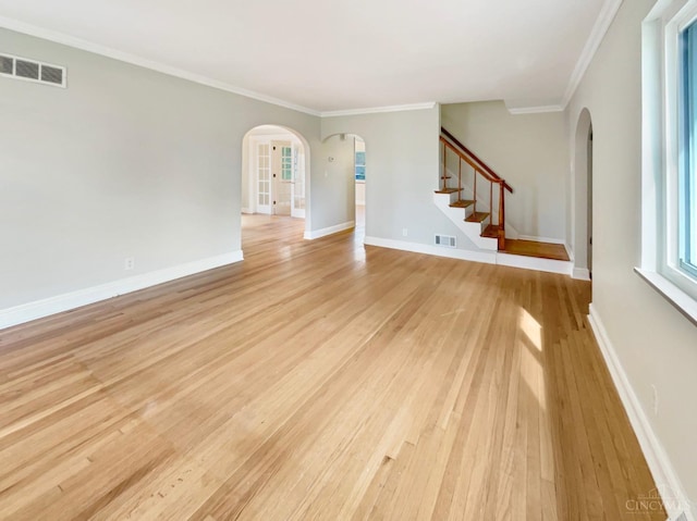 7046 Beechmont Ave, Anderson Twp, OH 45230 - spare room featuring arched walkways, light wood finished floors, stairs, and ornamental molding