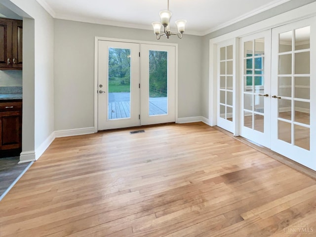 7046 Beechmont Ave, Anderson Twp, OH 45230 - unfurnished dining area featuring french doors, ornamental molding, light wood-type flooring, a chandelier, and baseboards