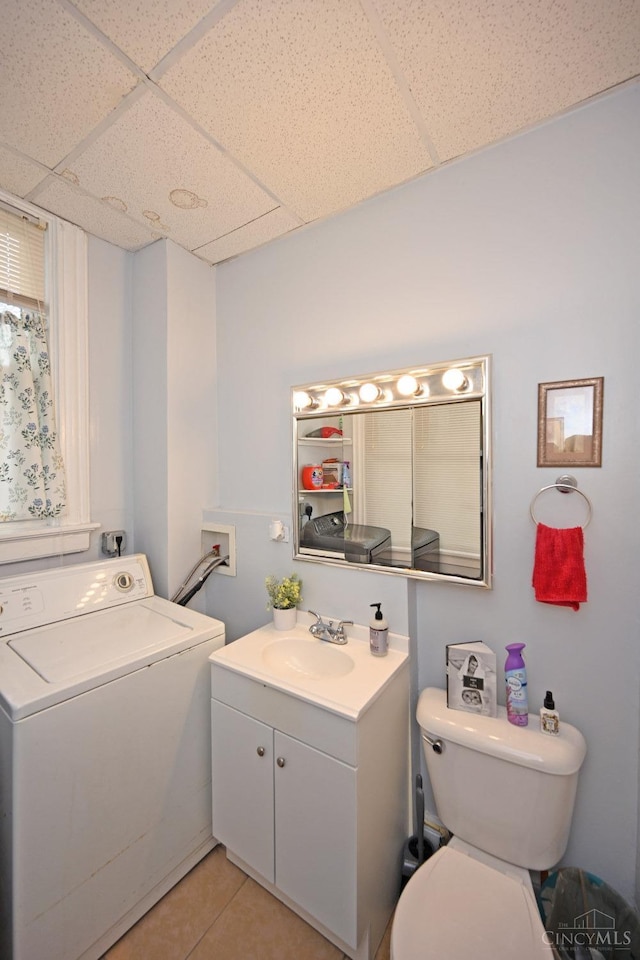 bathroom featuring tile patterned floors, toilet, vanity, a paneled ceiling, and washer / clothes dryer