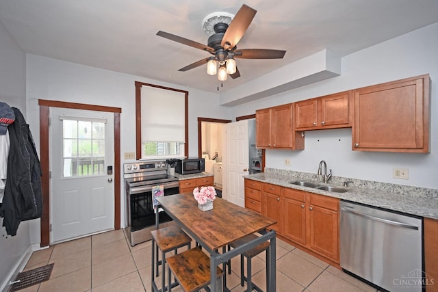 kitchen with light tile patterned flooring, visible vents, stainless steel appliances, and a sink