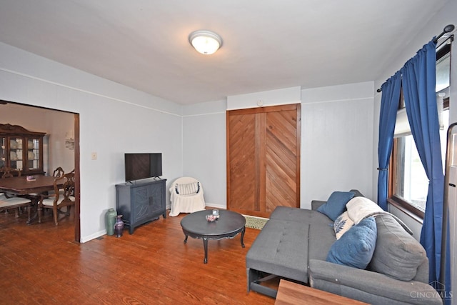 living room featuring baseboards and wood finished floors