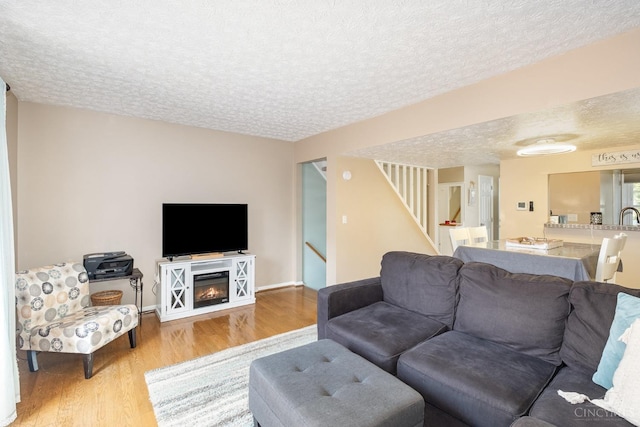 3690 Parfore Ct, Pierce Twp, OH 45245 - living room featuring wood finished floors, a textured ceiling, and stairs