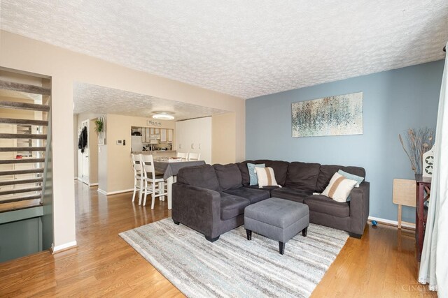 3690 Parfore Ct, Pierce Twp, OH 45245 - living area with baseboards, a textured ceiling, and light wood-style floors