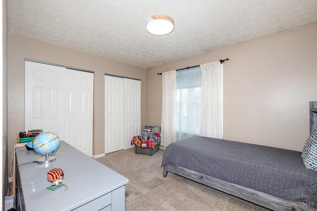 3690 Parfore Ct, Pierce Twp, OH 45245 - bedroom with two closets, light carpet, and a textured ceiling