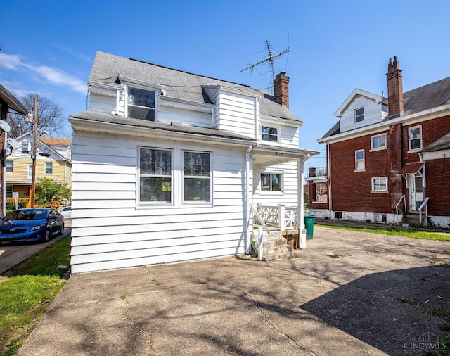 back of property featuring entry steps