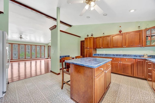 4092 Snowhill Rd, Perry Twp, OH 45118 - kitchen featuring ceiling fan, dark countertops, a center island, and freestanding refrigerator