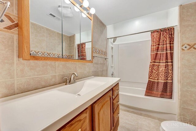 4092 Snowhill Rd, Perry Twp, OH 45118 - bathroom featuring visible vents, toilet, vanity, tile walls, and shower / tub combo