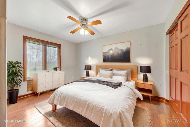 4092 Snowhill Rd, Perry Twp, OH 45118 - bedroom with light wood finished floors, a ceiling fan, baseboards, and a closet