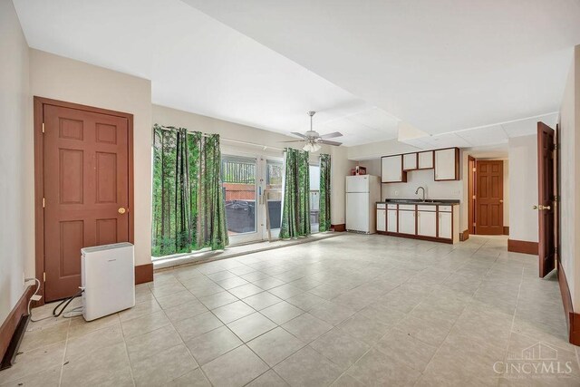 4092 Snowhill Rd, Perry Twp, OH 45118 - unfurnished living room with baseboards, a ceiling fan, a sink, and light tile patterned flooring