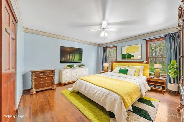 4092 Snowhill Rd, Perry Twp, OH 45118 - bedroom with ceiling fan, baseboards, wood finished floors, and multiple windows
