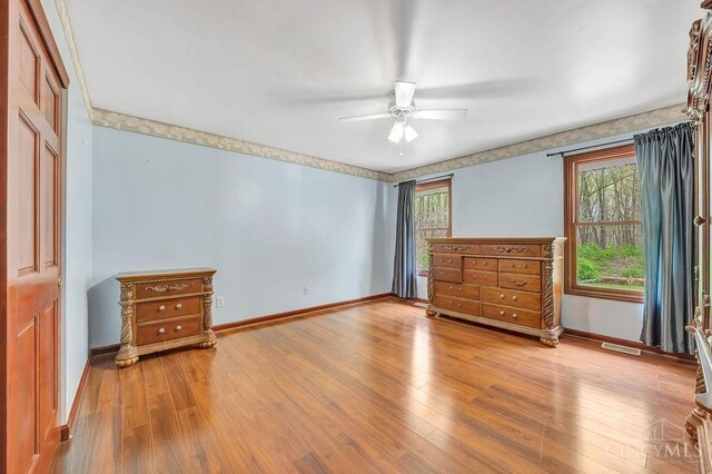 4092 Snowhill Rd, Perry Twp, OH 45118 - unfurnished bedroom with wood finished floors, visible vents, a ceiling fan, and baseboards