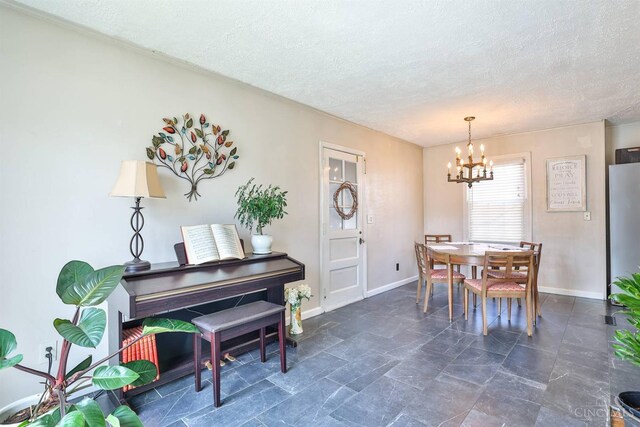 115 Maple Ave, Lebanon, OH 45036 - dining space featuring baseboards, a textured ceiling, and a chandelier