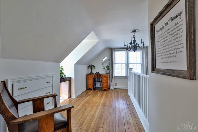 115 Maple Ave, Lebanon, OH 45036 - additional living space with light wood-style floors, lofted ceiling, baseboards, and a notable chandelier