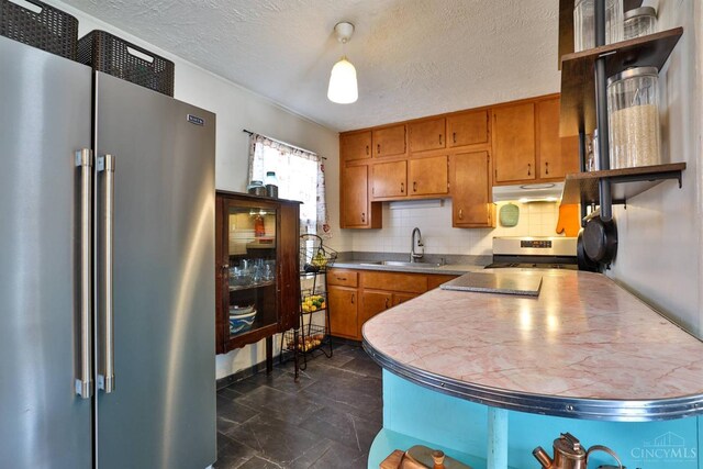 115 Maple Ave, Lebanon, OH 45036 - kitchen with tasteful backsplash, a sink, brown cabinetry, stainless steel appliances, and under cabinet range hood