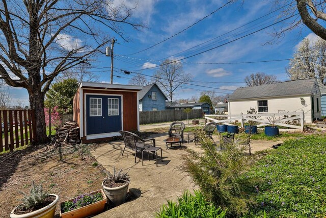 115 Maple Ave, Lebanon, OH 45036 - view of yard featuring a vegetable garden, a fenced backyard, a shed, an outdoor structure, and an outdoor fire pit