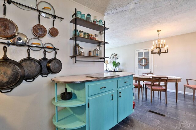 115 Maple Ave, Lebanon, OH 45036 - kitchen featuring open shelves, a textured ceiling, decorative light fixtures, blue cabinetry, and a notable chandelier