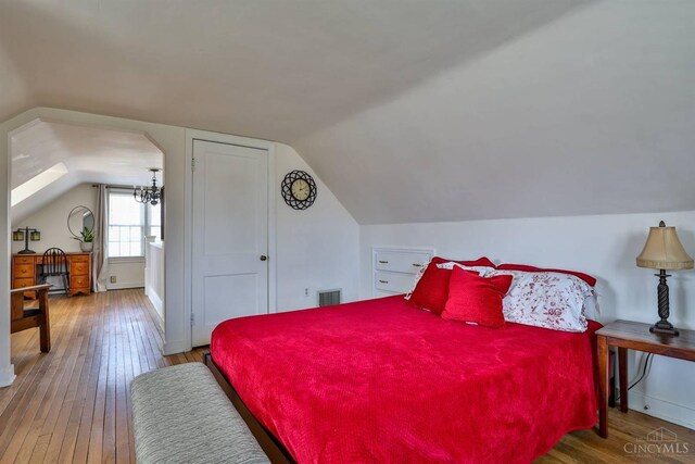 115 Maple Ave, Lebanon, OH 45036 - bedroom featuring hardwood / wood-style floors, visible vents, and lofted ceiling