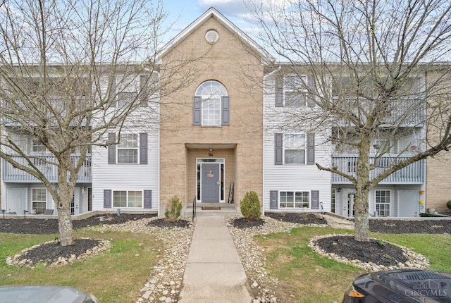 multi unit property with brick siding and central air condition unit