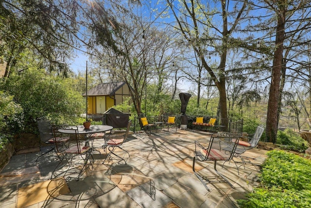 3725 Dogwood Ln, Columbia Twp, OH 45213 - view of patio / terrace with a shed and outdoor dining area