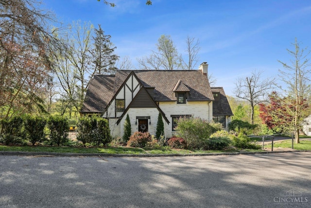 3725 Dogwood Ln, Columbia Twp, OH 45213 - tudor home featuring stone siding and a chimney
