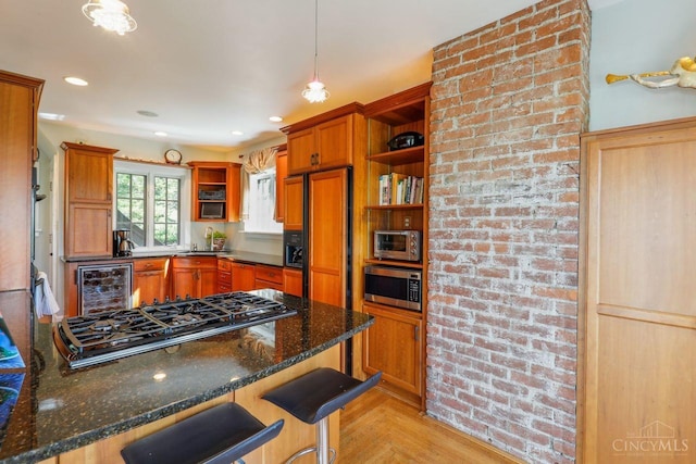 3725 Dogwood Ln, Columbia Twp, OH 45213 - kitchen with open shelves, built in appliances, wine cooler, brown cabinetry, and dark stone counters