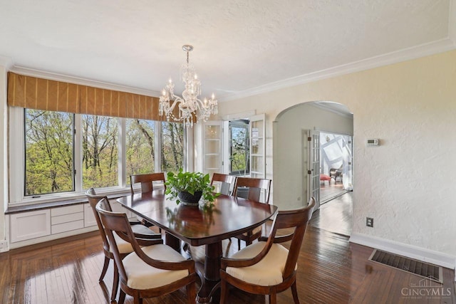 3725 Dogwood Ln, Columbia Twp, OH 45213 - dining area featuring plenty of natural light, arched walkways, dark wood-style floors, a textured wall, and ornamental molding