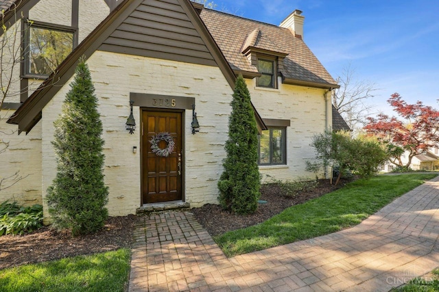 3725 Dogwood Ln, Columbia Twp, OH 45213 - entrance to property with a chimney, brick siding, and a high end roof