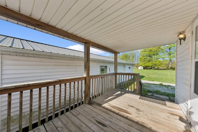 wooden terrace with a lawn